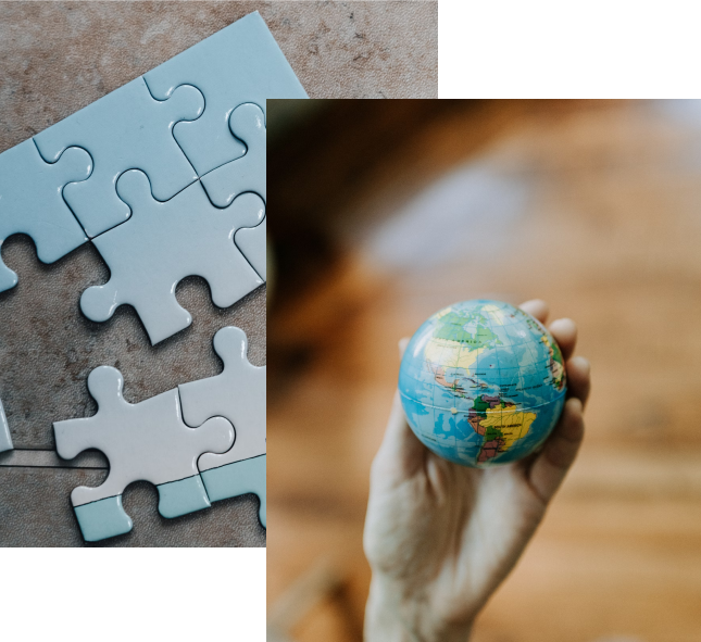 A puzzle being put together, with a hand holding a globe
